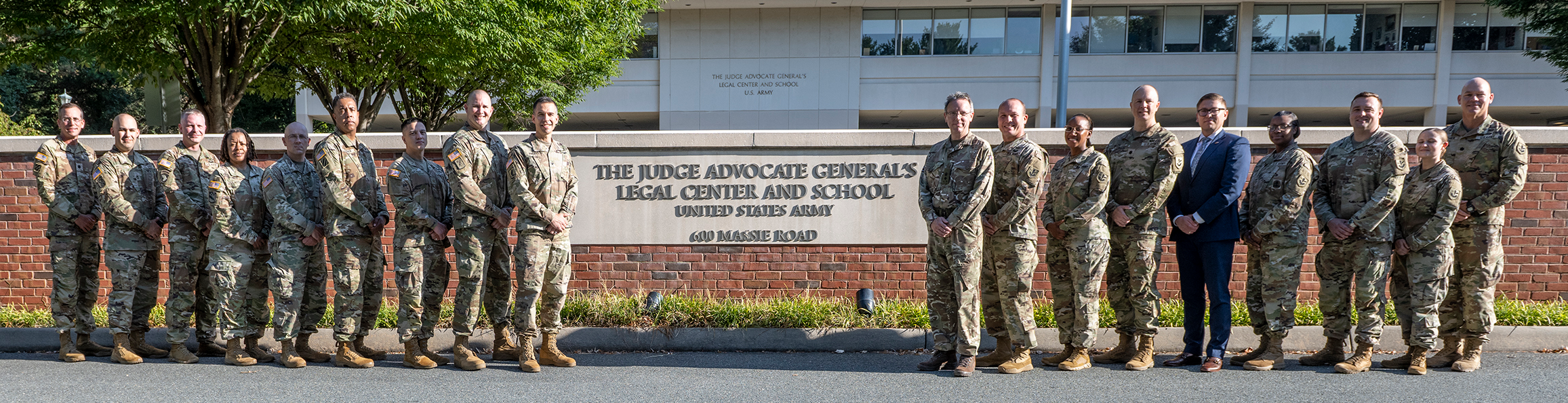 Soldiers posing in front of The Judge Advocate General's Legal Center and School