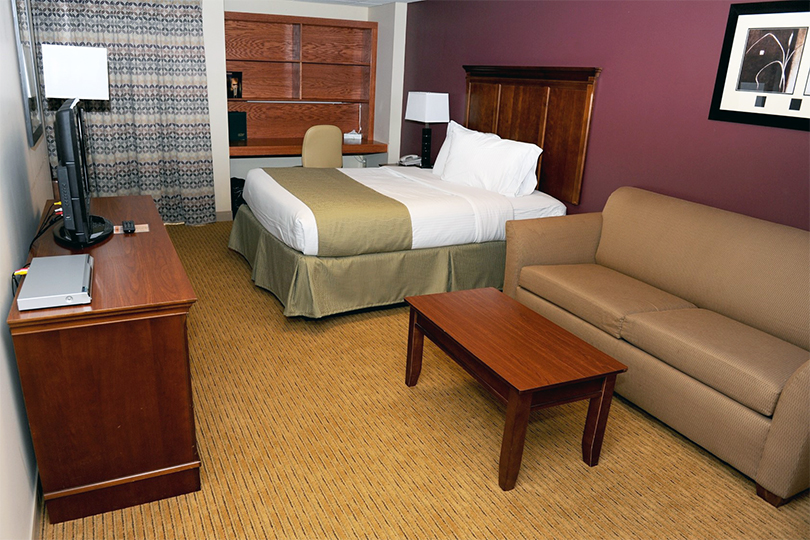 Bed, couch, and desk in hotel room