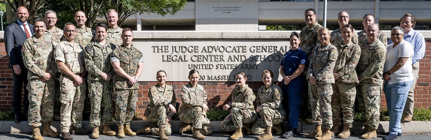 Soldiers posing in front of The Judge Advocate General's Legal Center and School