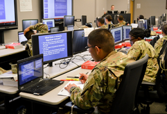 Soldiers in class, in front of computer monitors